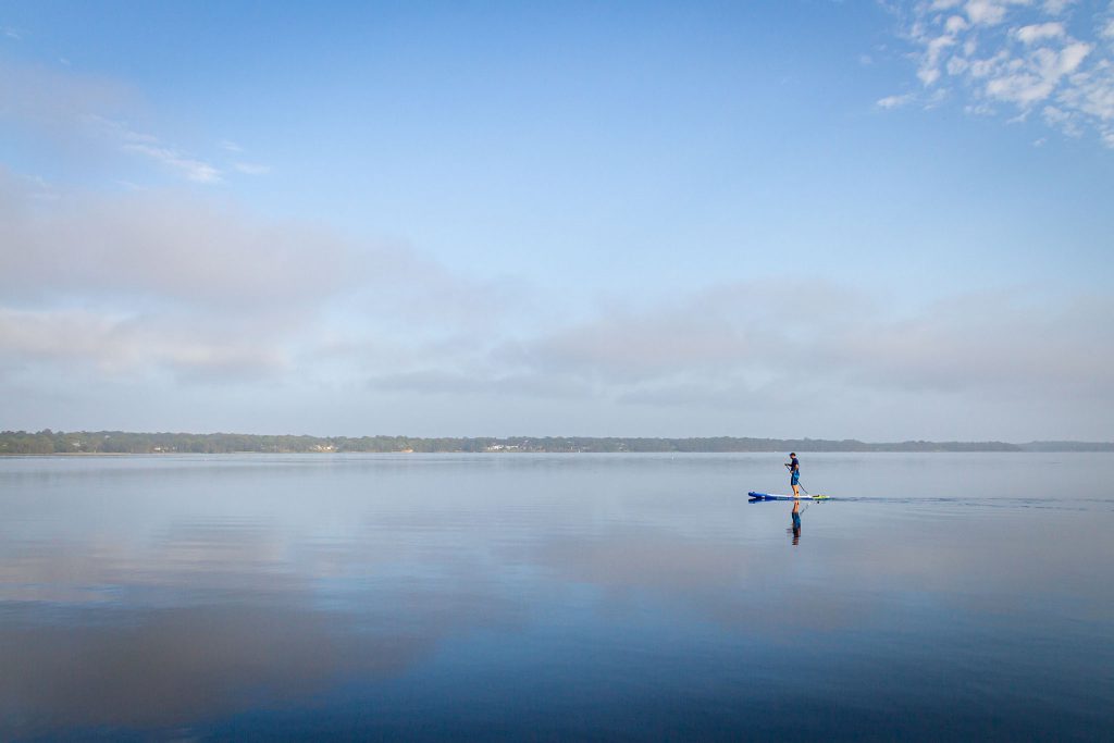 A standup paddle-boarder on Lake Munmorah