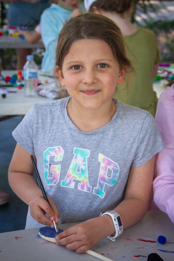 Emma painting a spoon