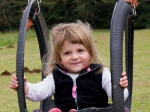 Emma enjoying the swings